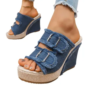 Stylish women's blue denim platform wedge sandals with fringed double buckle straps and woven sole