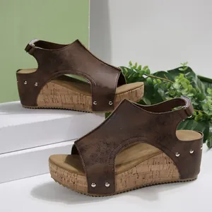 Stylish brown wedge sandals with peep toe and silver rivet details on cork platform
