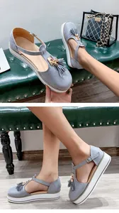 Macro view of blue faux-suede platform sandals featuring tassel and gold buckle details