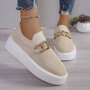 Close-up of beige platform flyknit shoes with a gold metal chain detail for women