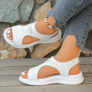 Detailed view of women's white knitted wedge sandals featuring a breathable hollow-out design