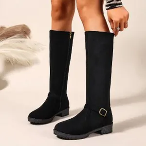Side view of black knee-high knight boots with low heel and decorative ankle buckle