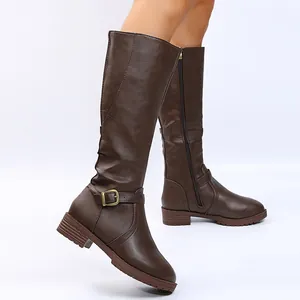 Side view detail of women's dark brown knee-high rider boots with buckle and zipper