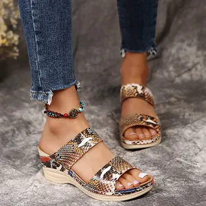 Detailed view of retro snakeskin print wedge sandals with thick platform soles for summer