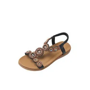 Detail view of Bohemian flat sandals with sparkling rhinestone floral decorations