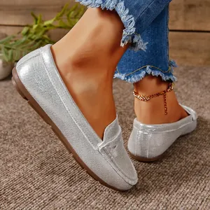 Detailed view of sparkling silver flat loafers with a comfortable slip-on design