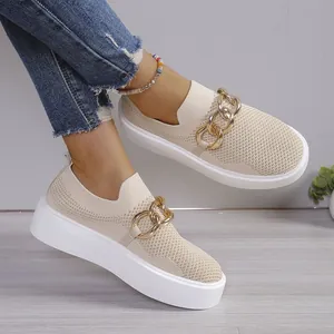 Detail view of women's beige flyknit sneakers with gold chain and platform sole