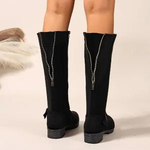 Rear view of black knee-high knight boots with zipper and chain detail on suede finish