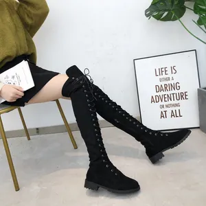 Detailed view of stylish black over-the-knee lace-up boots with comfortable flat soles.