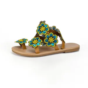 Detailed view of Bohemian flat sandals with colorful sequined floral embroidery