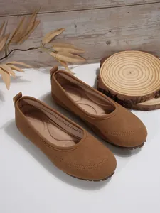 Classic women's brown suede slip-on loafers with soft padded insole and decorative stitching