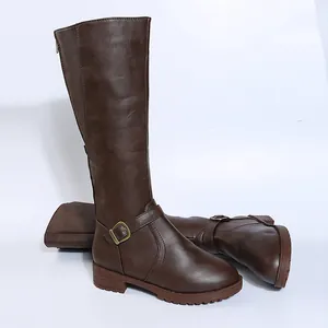 Brown leather knee-high knight boots with low heel and decorative buckle strap.