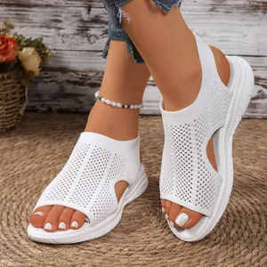 Detail showing the breathable white knit mesh and wedge sole of the women's sandals.