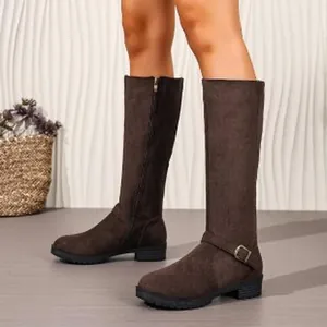 Detail view of dark brown suede knee-high knight boots with side zipper and buckle