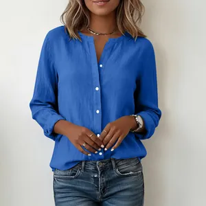 Detail shot of a blue slub cotton stand collar shirt for women with button closure.
