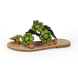 Detailed side view of Bohemian flat sandals with green and yellow sequin flower embroidery