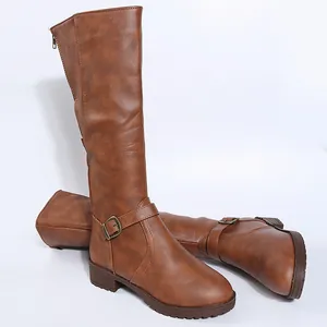 Detail view of brown faux leather knee-high knight boots with buckle and low heel.