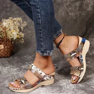 Close-up of women's retro wedge sandals with snake skin pattern and thick sole.