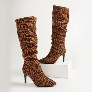 Detailed view of women's leopard print pleated high heel boots with pointed toe
