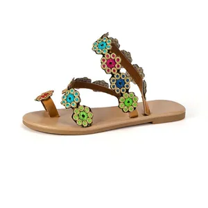 Side view detail of Bohemian flat sandals featuring colorful floral embroidery