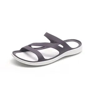 Detailed side view of minimalist dark purple flat sandals with white sole for summer wear