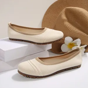 Close-up of beige breathable knit ballet flats with flexible soft rubber soles
