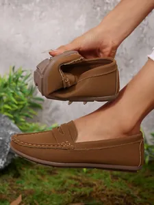 Flexible brown loafers for women with leather texture showing extreme softness and durability