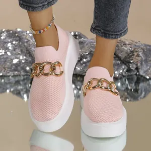 Detail shot of women's pink knit slip-on sneakers with gold chain and thick white sole