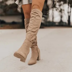 Stylish khaki suede chunky heel knee-high boots for women shown in a street fashion setting