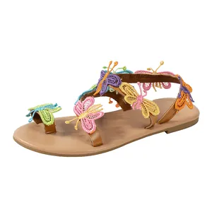 Detailed view of colorful embroidered butterflies on these Bohemian flat Roman sandals