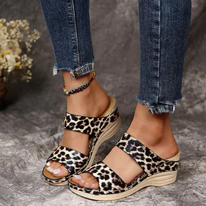 Close-up of leopard print wedge sandals with double straps and fish-mouth design