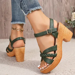 Close-up of green chunky heel sandals with woven platform and buckle ankle strap