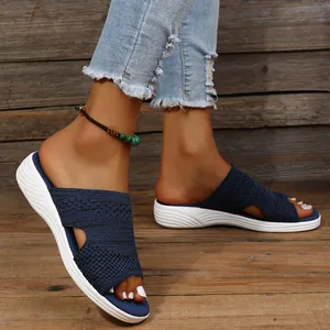 Detail view of blue knit flat slide sandals for women with comfortable thick white sole