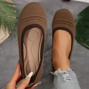 Detailed close-up of women's brown knitted flat shoes with a soft massage insole