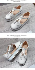 Elegant white tassel platform sandals with buckle ankle strap on wooden floor