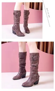 Detailed view of vintage brown tall boots with buckle straps and thick heels on model