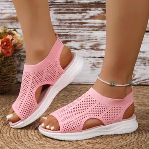 Detailed view of pink breathable mesh wedge sandals with hollow-out design