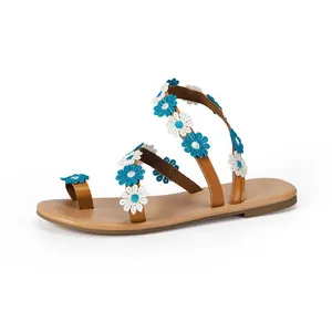 Side view of Bohemian flat sandals featuring blue and white daisy floral embroidery