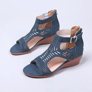 Detailed view of women's blue cutout wedge sandals with elegant ankle buckle strap.