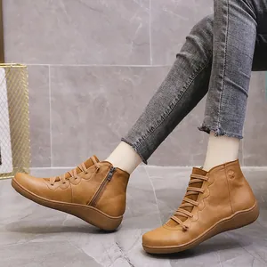 Detail view of brown casual leather ankle boots with side zipper for women.