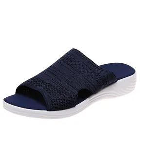 Side view detail of women's navy blue knitted flat slide sandals for summer fashion