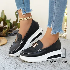 Side view of black leather platform loafers featuring a 5cm white sole and metal buckle