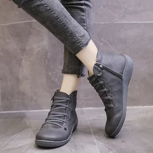 Close-up view of grey women's casual ankle boots featuring lace-up and side zipper