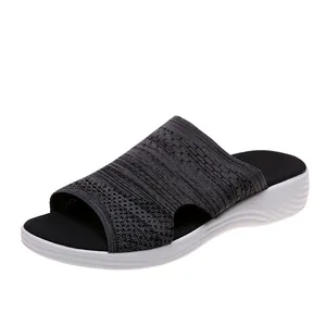 Detailed side view of fashionable grey knitted platform slide sandals for women