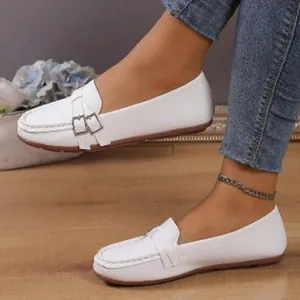Stylish white flat loafers for women featuring decorative side buckles and round toe