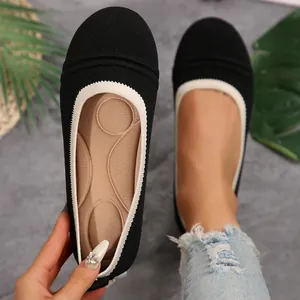 Detailed top view of women's black knit ballet flats featuring soft cushioned insoles