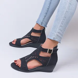 Close-up of women's navy blue cutout wedge sandals with adjustable buckle strap