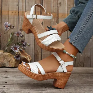 White woven platform sandals with chunky wood-textured heels and ankle straps.