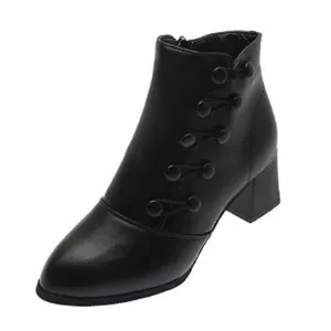 Detailed view of a black pointed toe ankle boot with side buttons and a chunky heel