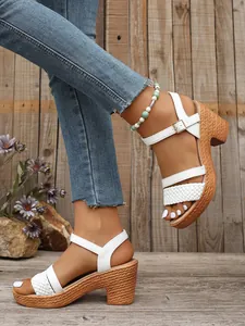 Detail view of white braided strap sandals with chunky heel and buckle ankle strap